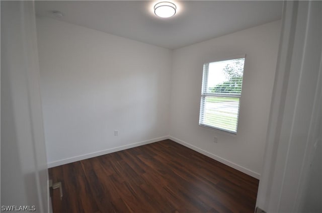 spare room with dark hardwood / wood-style floors