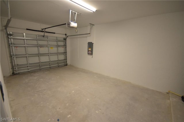 garage with a garage door opener and electric panel