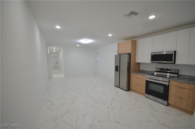 kitchen with white cabinetry and appliances with stainless steel finishes