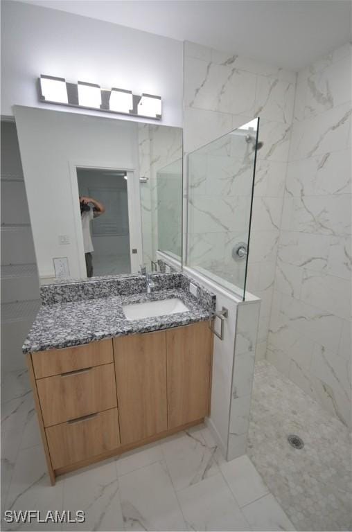 bathroom with vanity and tiled shower