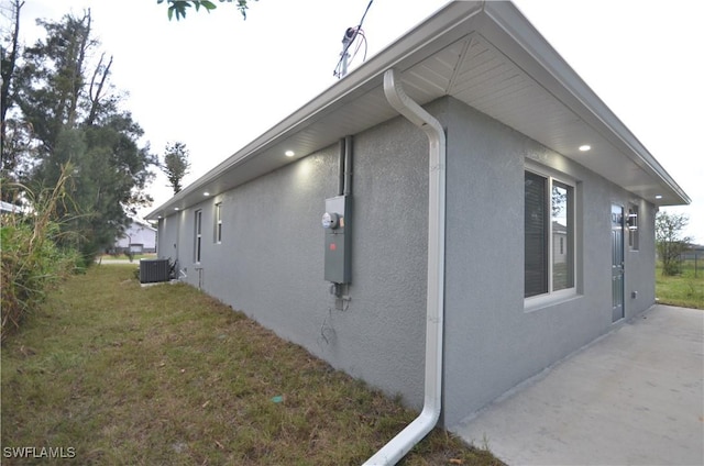 view of home's exterior with a yard and central air condition unit