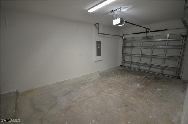 garage with a garage door opener and electric panel