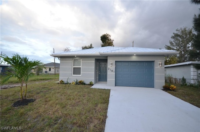 ranch-style house with a garage and a front yard