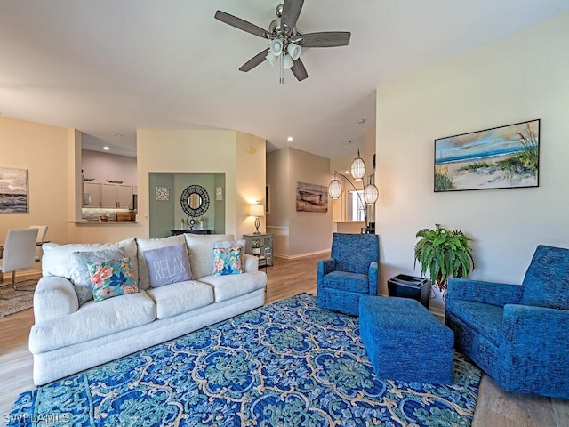 living room featuring ceiling fan and hardwood / wood-style flooring