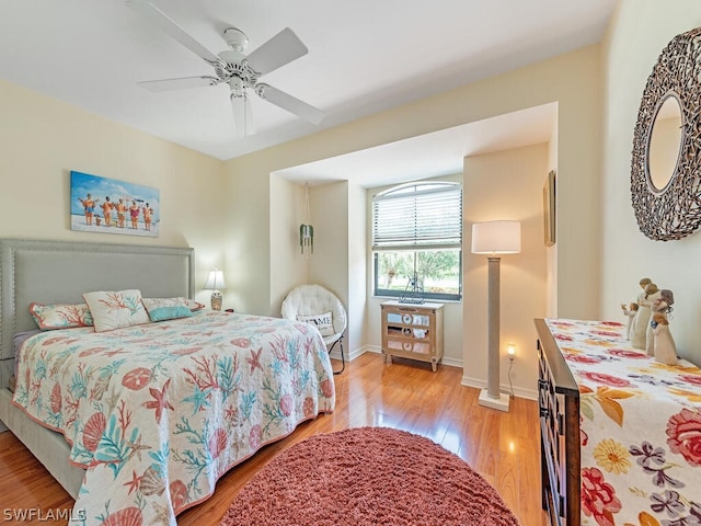 bedroom with light hardwood / wood-style flooring and ceiling fan