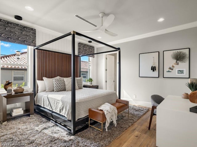 bedroom featuring ceiling fan, wood-type flooring, and crown molding