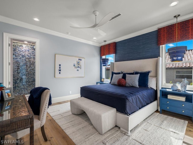 bedroom with ceiling fan, ornamental molding, and light hardwood / wood-style flooring