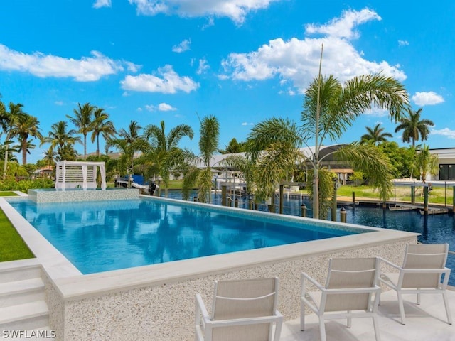 view of swimming pool with a water view and a patio