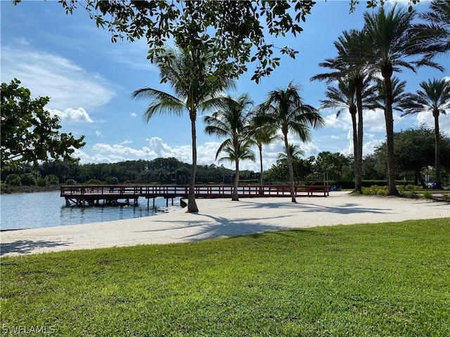 dock area featuring a water view and a lawn