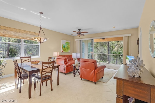 tiled dining room featuring plenty of natural light and ceiling fan