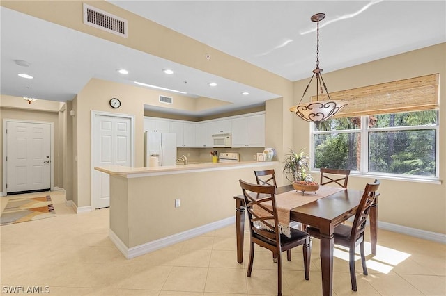 tiled dining room with sink