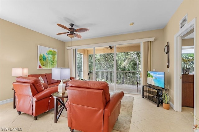 tiled living room featuring ceiling fan