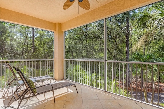 unfurnished sunroom featuring ceiling fan