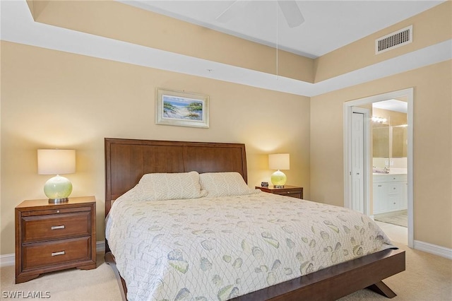 carpeted bedroom featuring connected bathroom