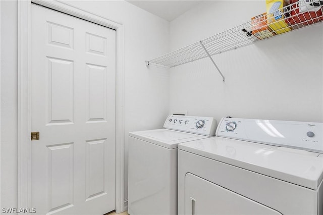 laundry room featuring washing machine and clothes dryer