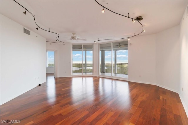 unfurnished room featuring ceiling fan and dark hardwood / wood-style flooring