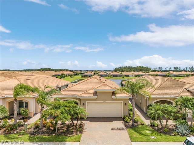 mediterranean / spanish-style home with a garage