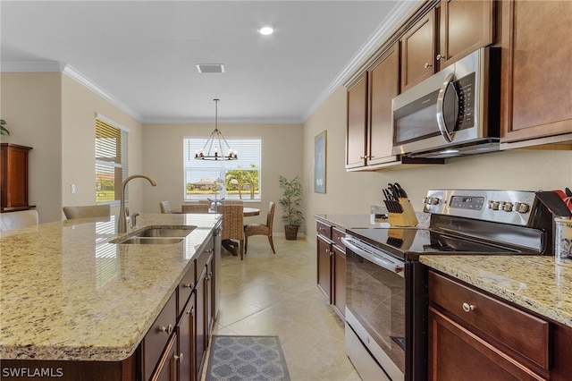 kitchen with light stone countertops, sink, appliances with stainless steel finishes, and an inviting chandelier