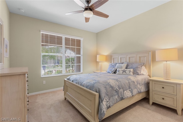 bedroom with ceiling fan and light colored carpet