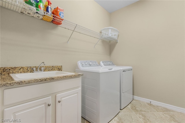 laundry area featuring washing machine and dryer and sink