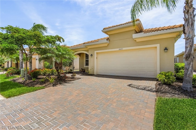 mediterranean / spanish home with a garage