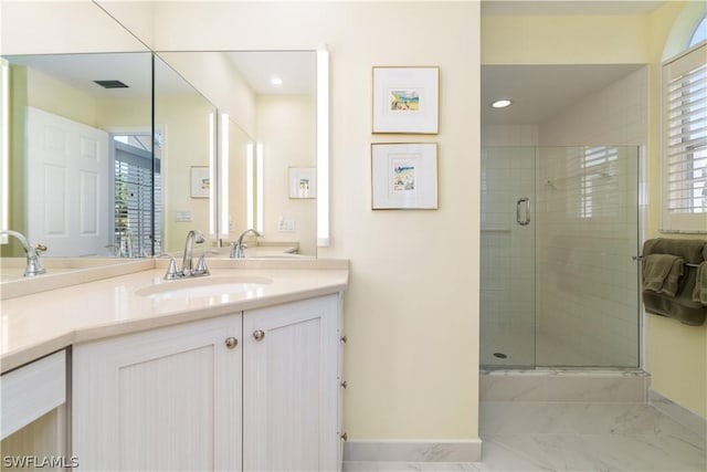 bathroom featuring a shower with door, a wealth of natural light, and vanity