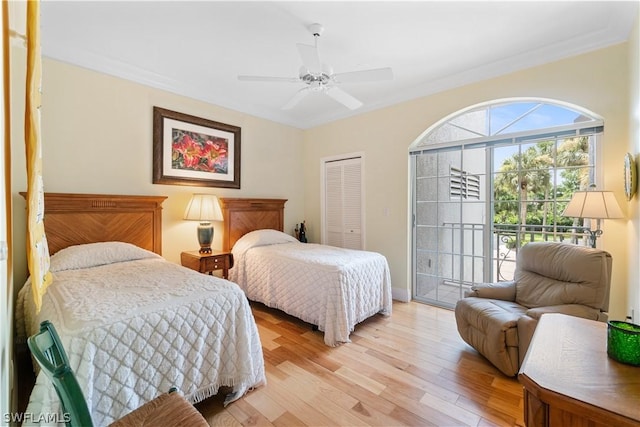 bedroom featuring ceiling fan, crown molding, a closet, light wood-type flooring, and access to exterior