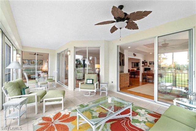 sunroom / solarium featuring ceiling fan and a tray ceiling