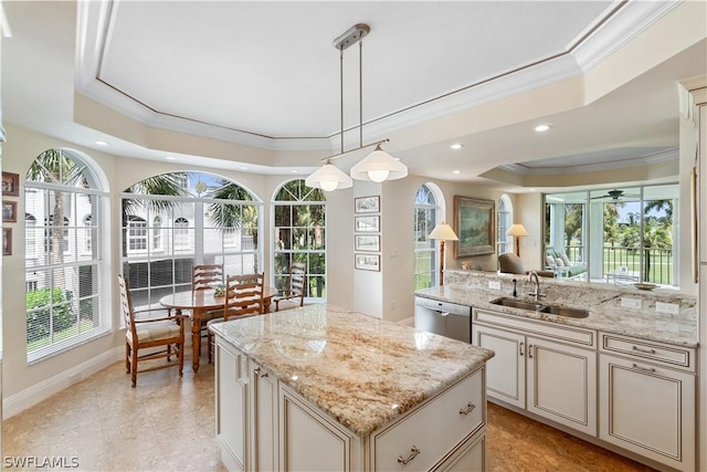 kitchen with light stone countertops, dishwasher, sink, a raised ceiling, and pendant lighting