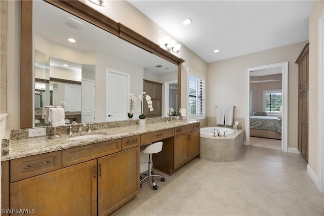 bathroom with a relaxing tiled tub and vanity