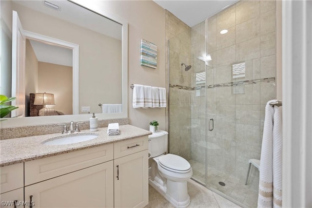 bathroom with vanity, tile patterned floors, toilet, and walk in shower