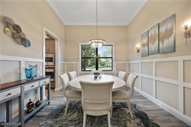 dining space featuring ornamental molding and dark hardwood / wood-style floors