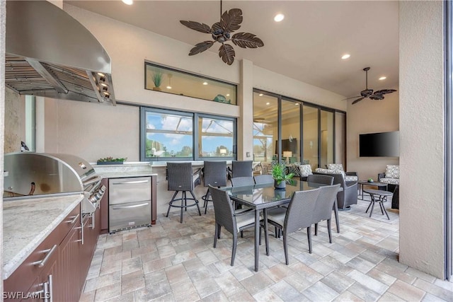 view of patio / terrace with area for grilling, a grill, and ceiling fan