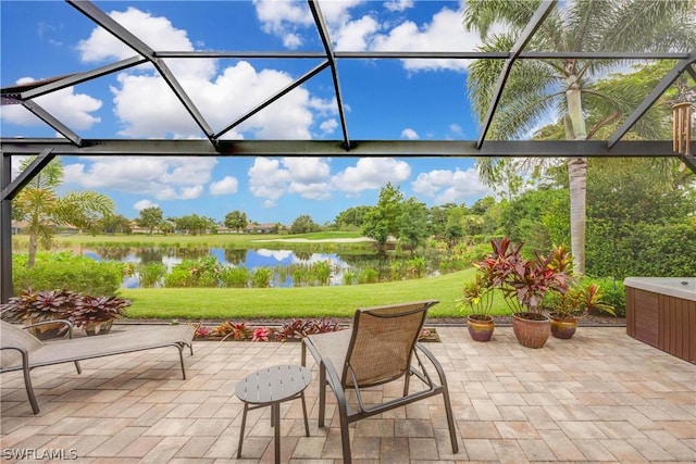 view of patio featuring a water view and a lanai