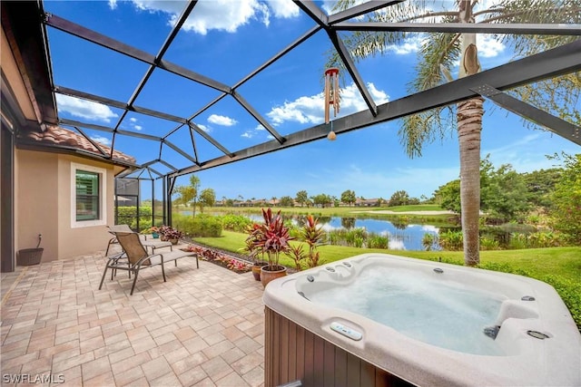 view of patio / terrace featuring a hot tub, a water view, and a lanai