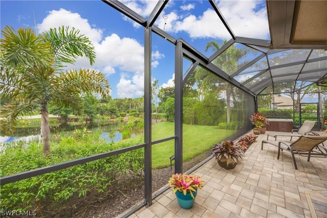 unfurnished sunroom featuring a water view