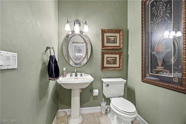 bathroom with baseboards, toilet, and tile patterned floors