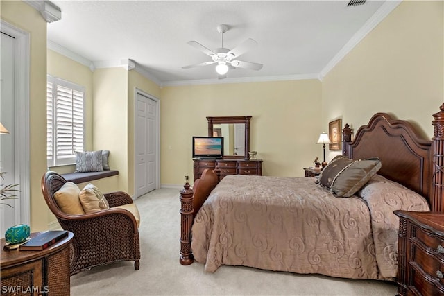 carpeted bedroom featuring a ceiling fan, baseboards, ornamental molding, and a closet