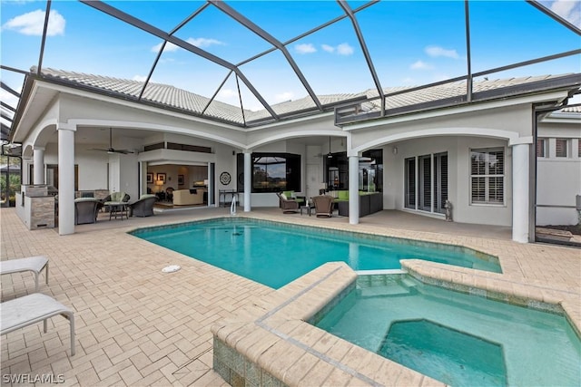 view of pool featuring a pool with connected hot tub, a patio area, ceiling fan, and an outdoor living space