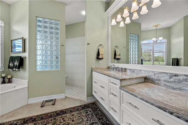 bathroom featuring a garden tub, an inviting chandelier, vanity, walk in shower, and tile patterned floors