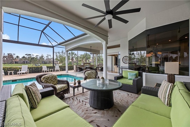 exterior space with ceiling fan, outdoor lounge area, a lanai, and an outdoor pool