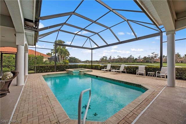 view of swimming pool with a patio area, a pool with connected hot tub, and glass enclosure