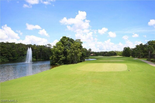 view of home's community with view of golf course and a water view