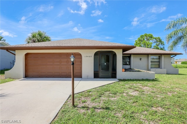 ranch-style home featuring a garage and a front lawn