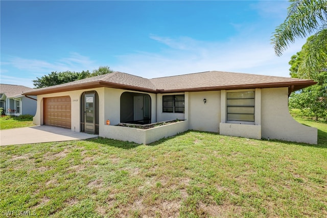 view of front of house with a garage and a front lawn