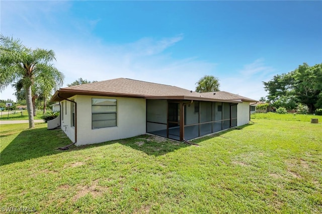 rear view of property featuring a yard