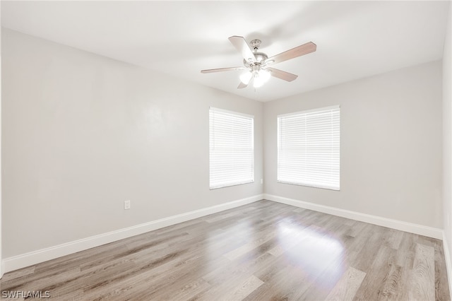 spare room featuring light hardwood / wood-style flooring and ceiling fan