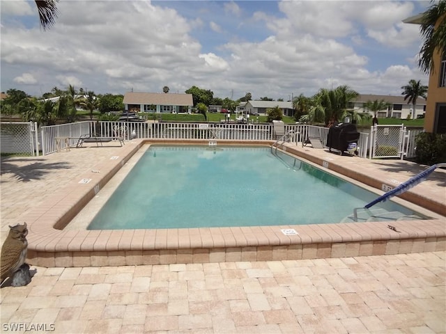 view of swimming pool with a patio area