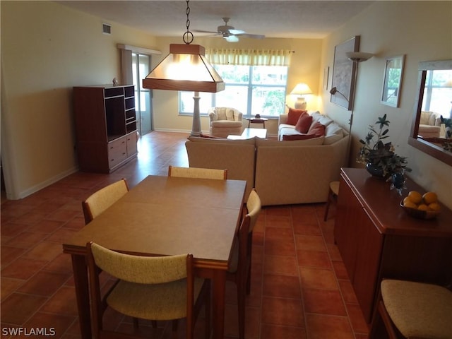 dining room featuring ceiling fan and tile patterned flooring