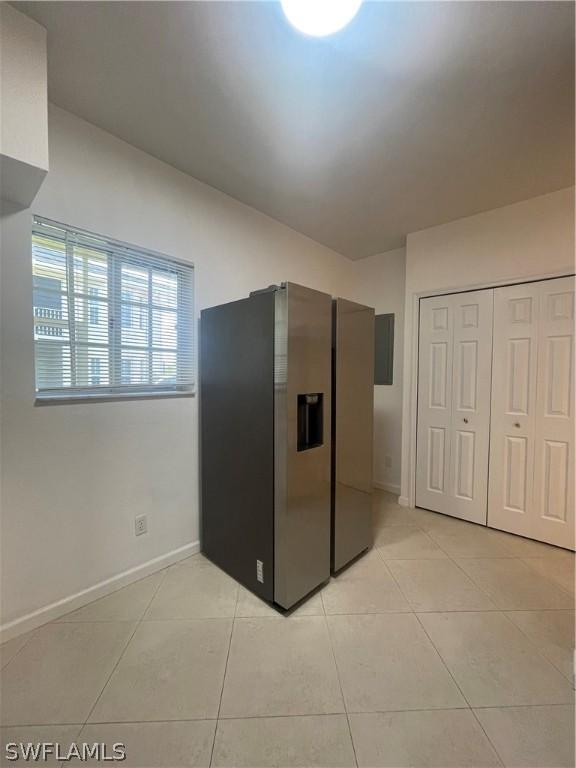 kitchen with stainless steel fridge and light tile patterned floors